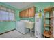Laundry room with washer, dryer, utility sink, and hot water heater at 6531 Red Grange Blvd, Indian Lake Estates, FL 33855
