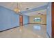 Spacious living room boasts tile floors, a ceiling fan, and views of the backyard at 6531 Red Grange Blvd, Indian Lake Estates, FL 33855