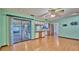 Open living space with a sliding glass door to a screened patio and an adjacent kitchen at 6531 Red Grange Blvd, Indian Lake Estates, FL 33855