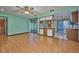 Living room with hard wood floors and view into the kitchen at 6531 Red Grange Blvd, Indian Lake Estates, FL 33855