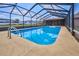 Screened pool with a ladder at 6531 Red Grange Blvd, Indian Lake Estates, FL 33855