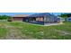 Screened in pool with covered patio and partially fenced in grass area at 6531 Red Grange Blvd, Indian Lake Estates, FL 33855