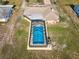 Aerial view of a private screened pool and backyard at 6531 Red Grange Blvd, Indian Lake Estates, FL 33855