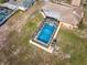 Aerial view of the home featuring a private screened pool at 6531 Red Grange Blvd, Indian Lake Estates, FL 33855