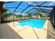 Screened-in pool area with a large pool and spacious deck for lounging at 6531 Red Grange Blvd, Indian Lake Estates, FL 33855