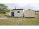 View of three outdoor storage sheds with varied construction for lawn tools and storage at 6531 Red Grange Blvd, Indian Lake Estates, FL 33855