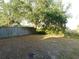 Backyard with mature trees and wood fence for privacy at 6954 Glenbrook Dr, Lakeland, FL 33811