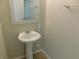 Powder bath with pedestal sink, neutral paint and tiled floor is perfect for guests at 6954 Glenbrook Dr, Lakeland, FL 33811