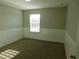 This cozy bedroom features neutral walls, a plush carpet, and classic beadboard paneling at 6954 Glenbrook Dr, Lakeland, FL 33811