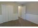 Carpeted bedroom with double door closet and paneled accent wall at 6954 Glenbrook Dr, Lakeland, FL 33811