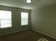 The carpeted bedroom has two windows providing ample natural light at 6954 Glenbrook Dr, Lakeland, FL 33811