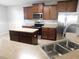 Open kitchen featuring stainless steel appliances, tile backsplash, and an island at 6954 Glenbrook Dr, Lakeland, FL 33811