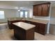 Open kitchen with wooden cabinets, center island and view to Gathering room at 6954 Glenbrook Dr, Lakeland, FL 33811