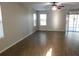 Bright living room with laminate floors, a ceiling fan, and sliding glass doors at 6954 Glenbrook Dr, Lakeland, FL 33811