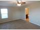 The main bedroom offers a ceiling fan, a window, and an ensuite bathroom at 6954 Glenbrook Dr, Lakeland, FL 33811