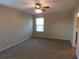 Carpeted main bedroom has a window, ceiling fan, and ensuite bathroom at 6954 Glenbrook Dr, Lakeland, FL 33811
