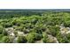 Expansive aerial perspective showcasing the verdant landscape and community homes at 7165 Cr 655, Bushnell, FL 33513