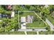 Aerial view showcasing the home's layout, including the main house, detached garage, and surrounding greenery at 7165 Cr 655, Bushnell, FL 33513