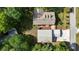 Overhead view showcasing the home's roof, detached garage, driveway, and surrounding landscaping at 7165 Cr 655, Bushnell, FL 33513