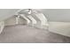 Finished attic space with angled ceilings, neutral carpet, and natural light from window at 7165 Cr 655, Bushnell, FL 33513