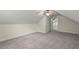 Finished attic space featuring carpet flooring, closet, and bright natural lighting at 7165 Cr 655, Bushnell, FL 33513