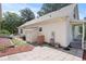 The backyard is white with a stone patio and light mulched flower beds at 7165 Cr 655, Bushnell, FL 33513