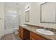 Bathroom with dual vanities, a framed mirror, and a shower-tub combination at 7165 Cr 655, Bushnell, FL 33513