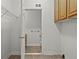 A view of the laundry room leading to a half bathroom with neutral paint and tile flooring at 7165 Cr 655, Bushnell, FL 33513