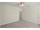 Cozy bedroom with soft carpeting, a ceiling fan, and a doorway leading to another room at 7165 Cr 655, Bushnell, FL 33513