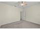Relaxing bedroom with a ceiling fan, soft carpet, and a doorway to an adjacent space at 7165 Cr 655, Bushnell, FL 33513