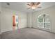 Main bedroom with large window, carpet flooring, and en suite bathroom at 7165 Cr 655, Bushnell, FL 33513