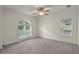 Bright bedroom with large windows offering abundant natural light and plush gray carpeting at 7165 Cr 655, Bushnell, FL 33513