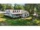 Charming two-story home with manicured lawn and inviting front porch at 7165 Cr 655, Bushnell, FL 33513