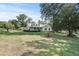 Well-maintained home with a lush front yard and mature trees at 7165 Cr 655, Bushnell, FL 33513