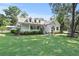 Charming two-story home with a welcoming front porch, well-maintained lawn, and beautiful, mature trees at 7165 Cr 655, Bushnell, FL 33513