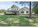 Inviting curb appeal with a charming front porch and manicured landscaping at 7165 Cr 655, Bushnell, FL 33513