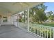 Inviting front porch with ceiling fans and a beautiful view of the lush, green lawn at 7165 Cr 655, Bushnell, FL 33513
