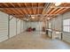 Interior of detached garage with exposed beams, workbench, and storage space at 7165 Cr 655, Bushnell, FL 33513