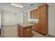 Eat-in kitchen boasts a center island, ample cabinet space, and neutral tile flooring at 7165 Cr 655, Bushnell, FL 33513