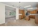 Spacious kitchen with stainless steel appliances, center island, and tile flooring extending into living area at 7165 Cr 655, Bushnell, FL 33513