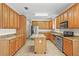 Spacious kitchen featuring wooden cabinets, granite countertops, stainless steel appliances, and a central island at 7165 Cr 655, Bushnell, FL 33513