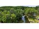 Aerial view of a tranquil waterway surrounded by lush, mature trees and landscaping at 7165 Cr 655, Bushnell, FL 33513