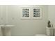 Simple half bathroom featuring stylish paint color, pedestal sink, and artwork at 1409 Acorn Meadow Loop, Eustis, FL 32726