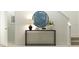 Elegant entryway with a black console table, decorative lamp, and stylish artwork at 1409 Acorn Meadow Loop, Eustis, FL 32726