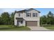 New two-story home featuring horizontal siding, gray shutters and a two car garage at 1409 Acorn Meadow Loop, Eustis, FL 32726
