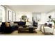 Comfortable living room with a plush sofa, stylish decor, and an adjacent modern kitchen at 1409 Acorn Meadow Loop, Eustis, FL 32726