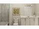 Clean bathroom features white cabinets, a shower with curtain, neutral wall color and modern fixture at 2105 Stake Out Way, Apopka, FL 32703