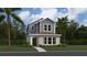 Charming two-story home showcasing a modern blue and grey exterior with lush landscaping and a welcoming entrance at 2105 Stake Out Way, Apopka, FL 32703