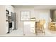 Modern kitchen boasts stainless steel appliances, white cabinets, and a stylish island with barstool seating at 2105 Stake Out Way, Apopka, FL 32703