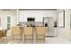 Bright kitchen featuring white cabinetry, stainless steel appliances, and a counter with seating for casual dining at 2105 Stake Out Way, Apopka, FL 32703